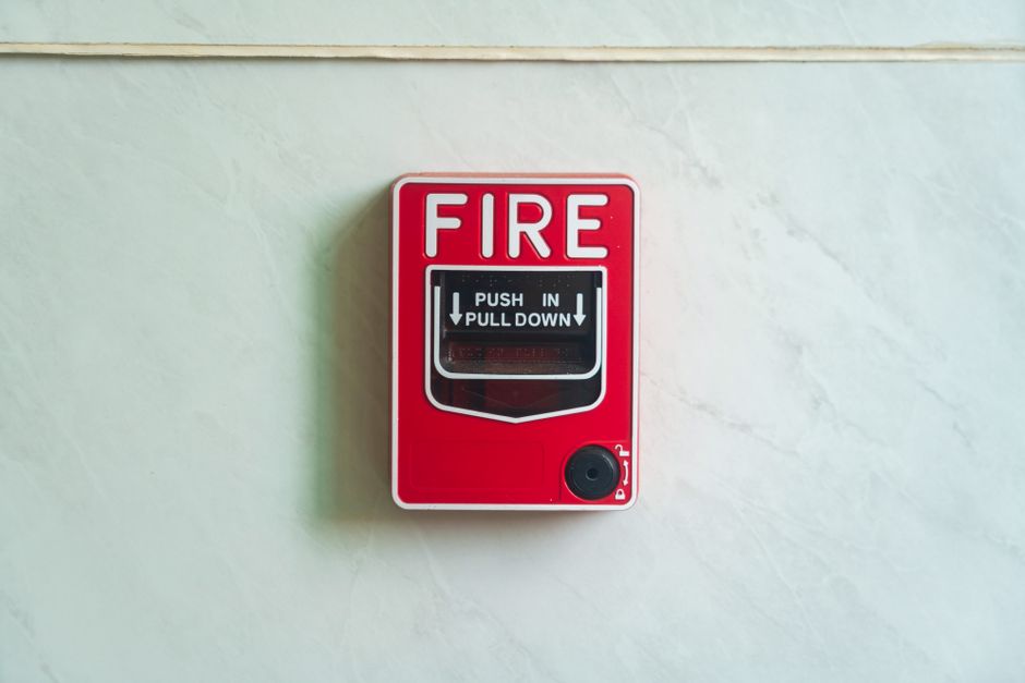Image of a wall mounted red fire alarm device for safety alerts and emergency preparedness.